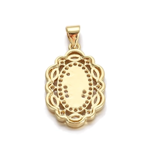 Detail of gold oval pendant with hollow pattern and sparkling rhinestone embellishments