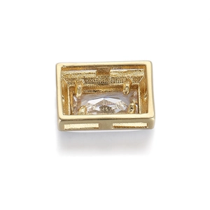 Macro detail of a rectangular 14K gold plated copper base with a clear baguette cut zircon