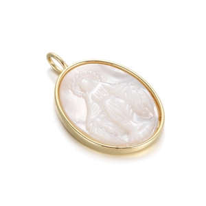 Detailed close-up of oval Virgin Mary pendant with golden metal frame and mother of pearl