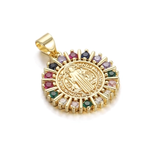 Macro shot of gold-plated Saint Benedict medal pendant with colorful zircon stones