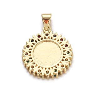 Detail of round gold-plated pendant with multicolored crystals and sunburst edge