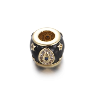 Close-up of gold-plated evil eye charm bead with black enamel and blue cubic zirconia