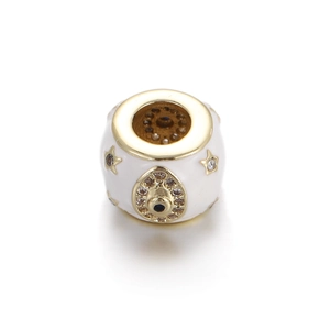 Macro detail of white enamel gold heart bead with star and evil eye gemstone inlay