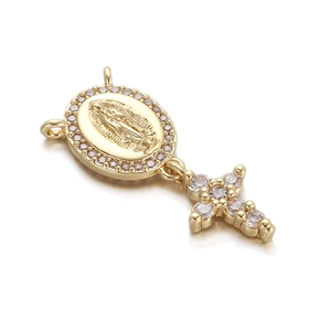 Detailed macro view of a gold-plated religious pendant with zircon-encrusted Mary and cross