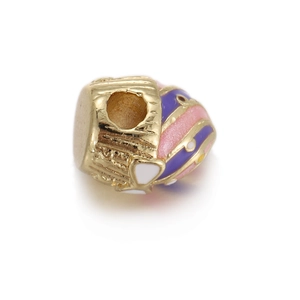 Close-up of heart-shaped gold-plated beads with colorful enamel for DIY jewelry