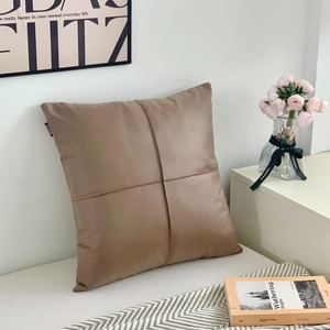Minimalist mocha brown faux leather pillow cover with cross stitching and HOME tag