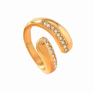 Adjustable golden bypass ring with sparkling crystals on a minimalist open band style