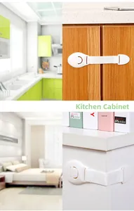 Close-up of child safety lock installed on white drawers and wood kitchen cabinets