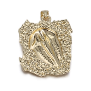 Detailed view of a punk-style gold skull pendant with hammered texture edges