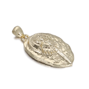 Detailed close-up of a gold-plated horseshoe crab pendant with unique relief texture