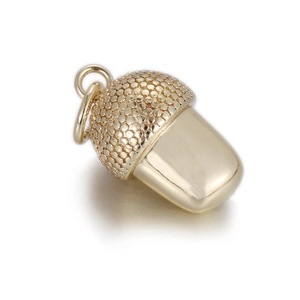 Close-up of golden acorn pendant with textured cap and smooth polished finish
