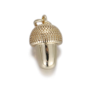 Detailed view of a golden acorn pendant with textured cap and polished metal surface