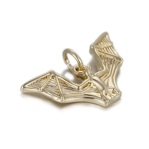 Detailed macro view of a gold-plated bat pendant for DIY jewelry and punk accessories