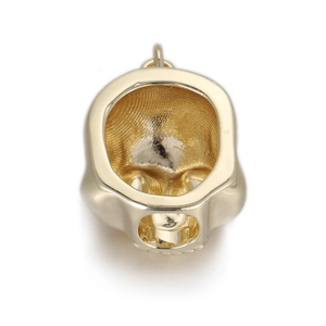 Detail of a golden skeleton skull pendant crafted in punk dinosaur fossil style for DIY jewelry