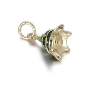 Detailed view of copper jewelry pendant with green enamel in a bell-shaped design
