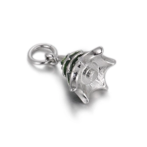 Detailed macro view of a silver-toned hollow pendant with green enamel and jump ring