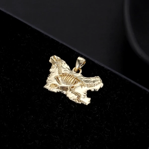 Golden dinosaur skeleton fossil pendant in punk style on a premium black velvet display