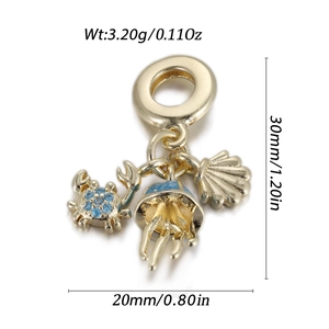 Detail of gold ocean charms featuring a blue crab, jellyfish, and seashell pendant