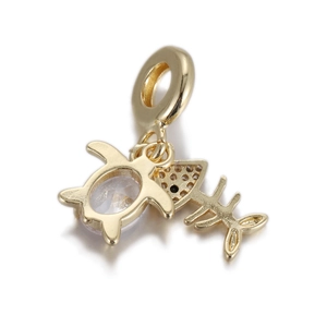 Detail of golden sea turtle charm with clear zircon stone and fishbone pendant