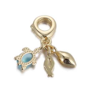 Detailed close-up of golden ocean-themed pendant featuring a sea turtle, fish, and leaf