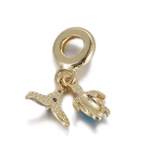 Detailed close-up of golden sea turtle and fish tail charm with blue textured accents