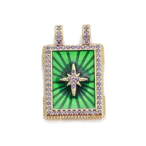 Close-up of a green enamel cross pendant with purple zircon inlay and gold finish