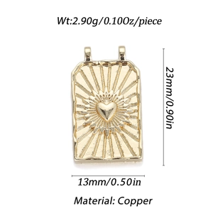 Detail view of rectangular brass pendant with embossed heart and sunburst ray design