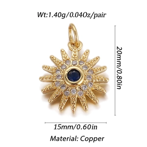 Dettaglio macro del ciondolo dorato a raggiera con pietra blu e inserti in zirconia cubica