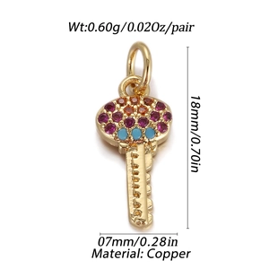 Macro detail of heart key charm in copper with colorful cubic zirconia stones and measurements