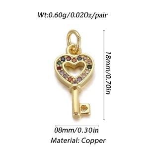 Detailed view of a gold-plated copper heart-key pendant with colorful zircon stones