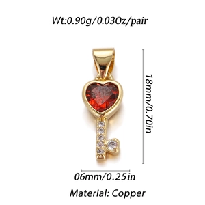 Detailed close-up of a 18mm golden copper heart key pendant with red and white zircons