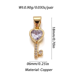 Macro view of gold heart key pendant with crystals showing dimensions 18mm by 6mm