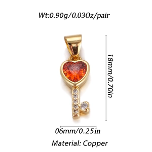 Detailed view of gold copper heart key pendant with red gemstone and dimensions info