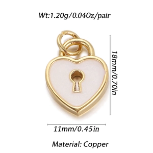 Detail view of heart-shaped gold-plated copper pendant with white enamel and keyhole