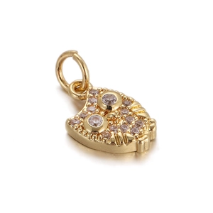 Detailed close-up of a gold owl pendant with sparkling zircons and a round metal loop