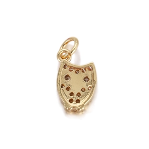 Detailed close-up of a golden owl charm with sparkling crystals for DIY jewelry design
