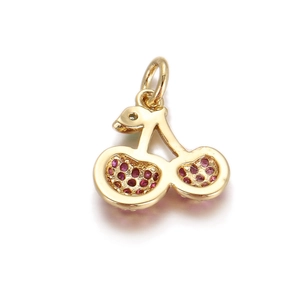 Detailed view of cherry heart pendant with red rhinestones and gold metal finish