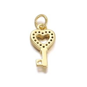 Detail of a golden heart key pendant with tiny dark stone accents and circular bail
