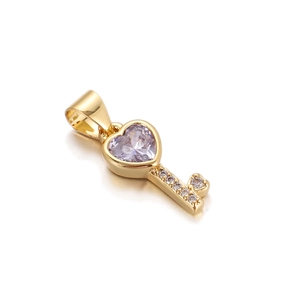Detail of gold heart key pendant featuring a purple gemstone and sparkling diamond accents