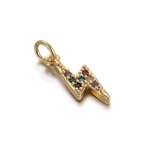 Macro view of gold lightning bolt pendant with colorful inlaid gemstones for DIY jewelry