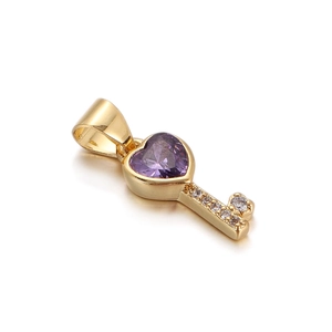 Detailed macro view of a golden key pendant featuring a heart-shaped purple zircon stone