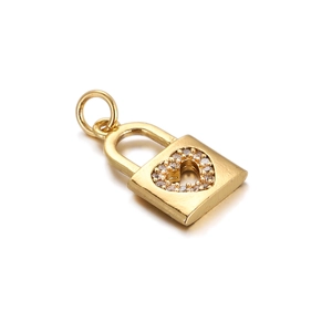 Macro shot of gold-plated heart-shaped lock pendant with white cubic zirconia stones