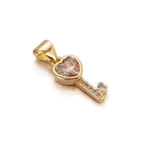 Detailed view of heart-shaped key pendant with champagne gemstone and zircon inlay