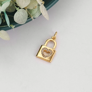 Detailed close-up of a golden heart lock pendant with sparkling zircon stone accents