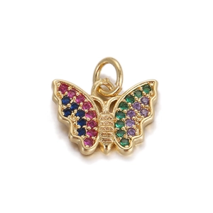 Detailed macro shot of a butterfly pendant with colorful zircon stones in gold plating