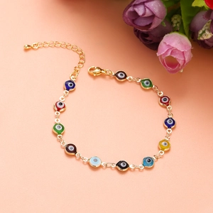 Close-up of golden evil eye bracelet with colorful beads and adjustable lobster clasp
