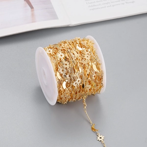 Golden DIY jewelry chain roll featuring textured star and moon charms on a spool