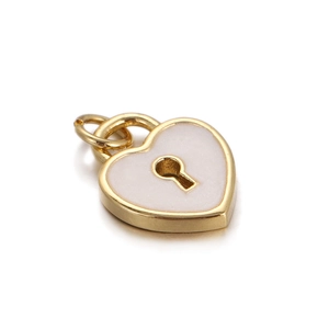 Close-up of heart-shaped charm with gold trim, white enamel inlay, and a keyhole detail