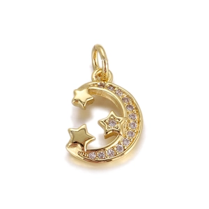 Macro shot of gold crescent moon and stars pendant with micro-pave cubic zirconia crystals