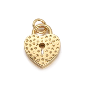 Macro view of a gold heart-shaped lock pendant with dot texture for DIY jewelry making